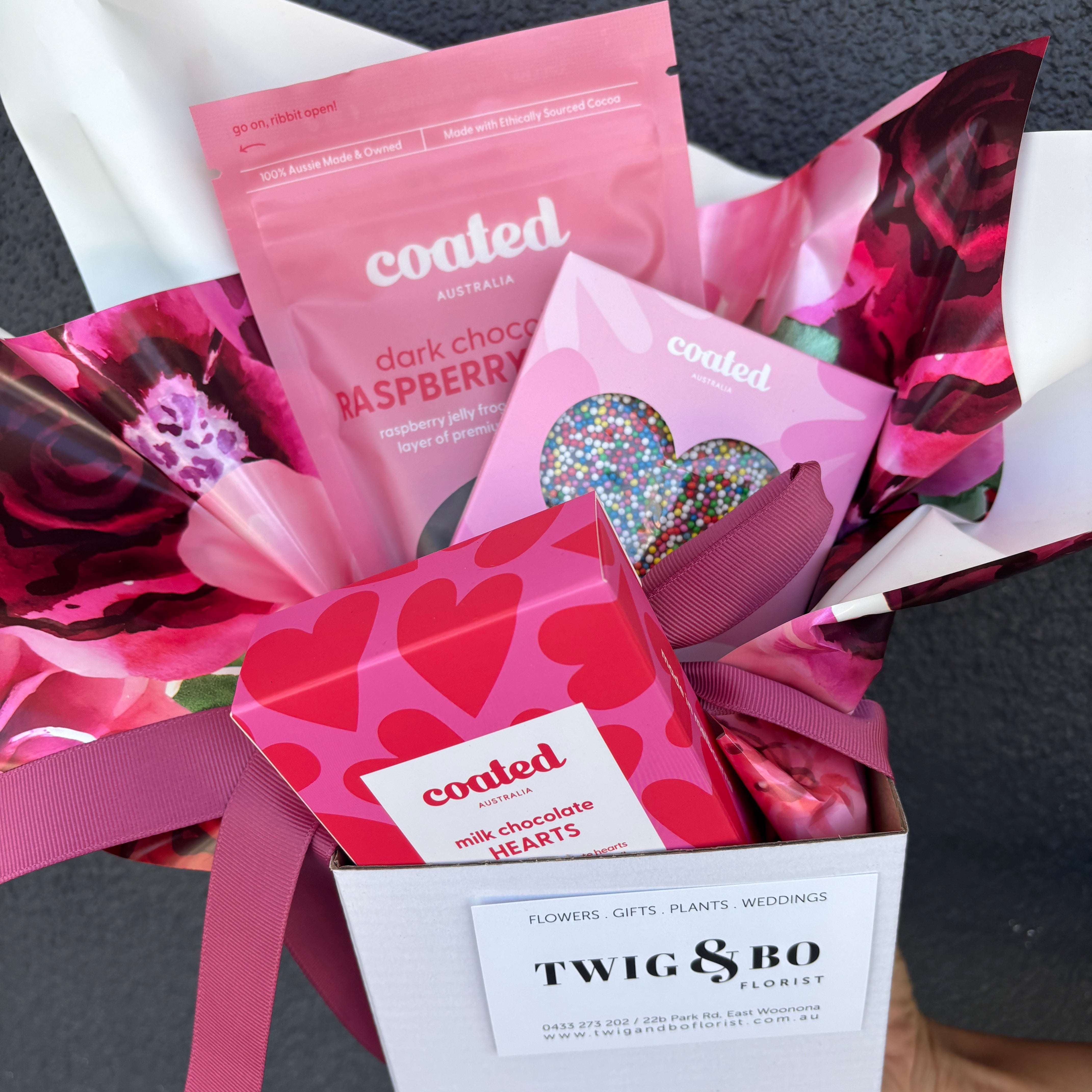 Box of 'coated' chocolate treats with pink and red packaging, featuring the brand 'Twig & Bo'.