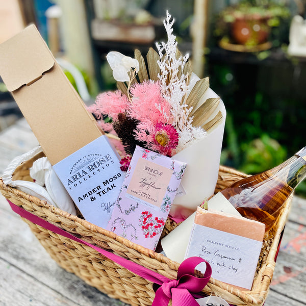 Seagrass Hamper Basket with simple ribbon finish with Dried flowers and a selection of gifts such as chocolates, a candle etc